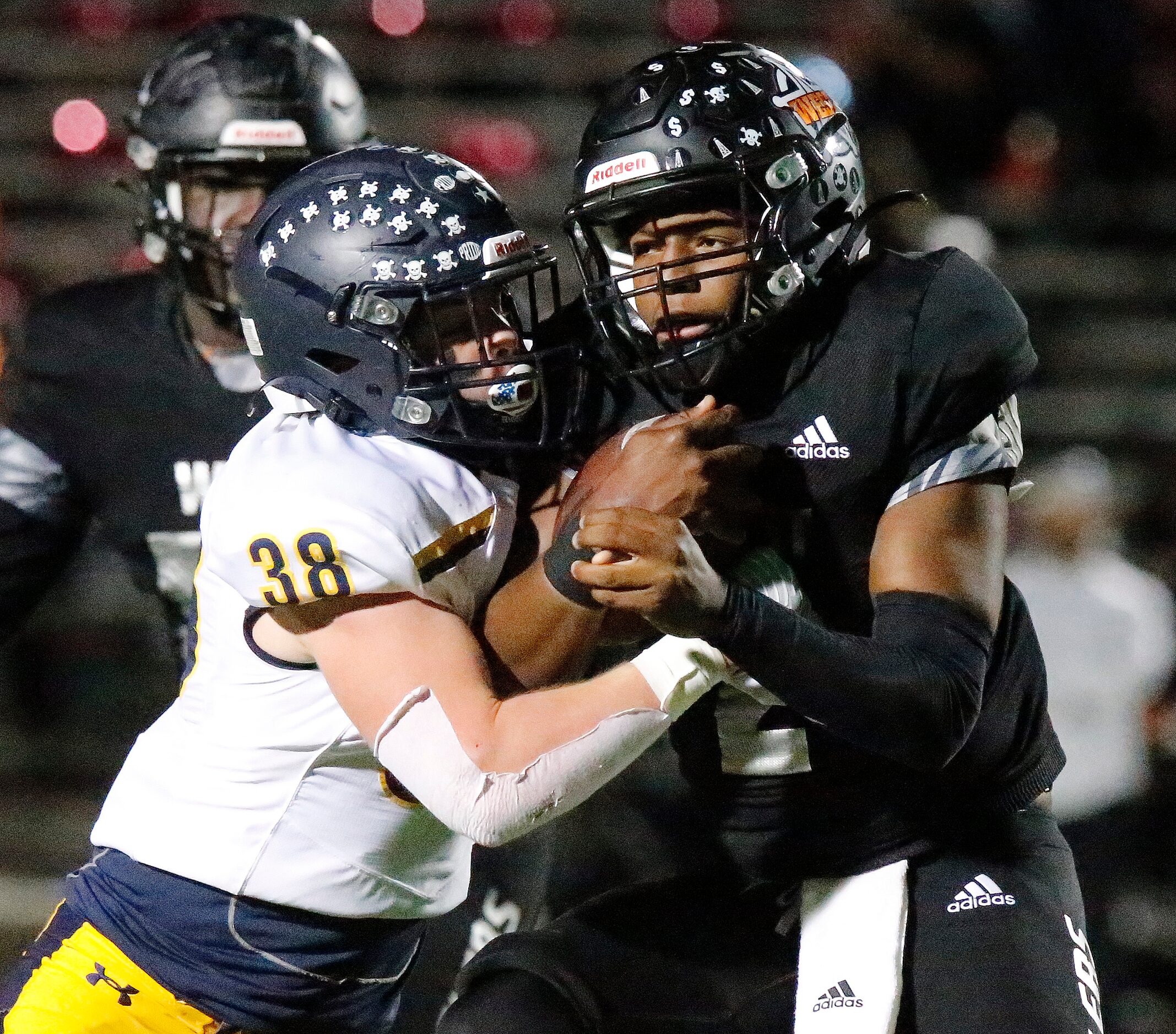 Highland Park High School linebacker Robert Rehme (38) meets West Mesquite High School...