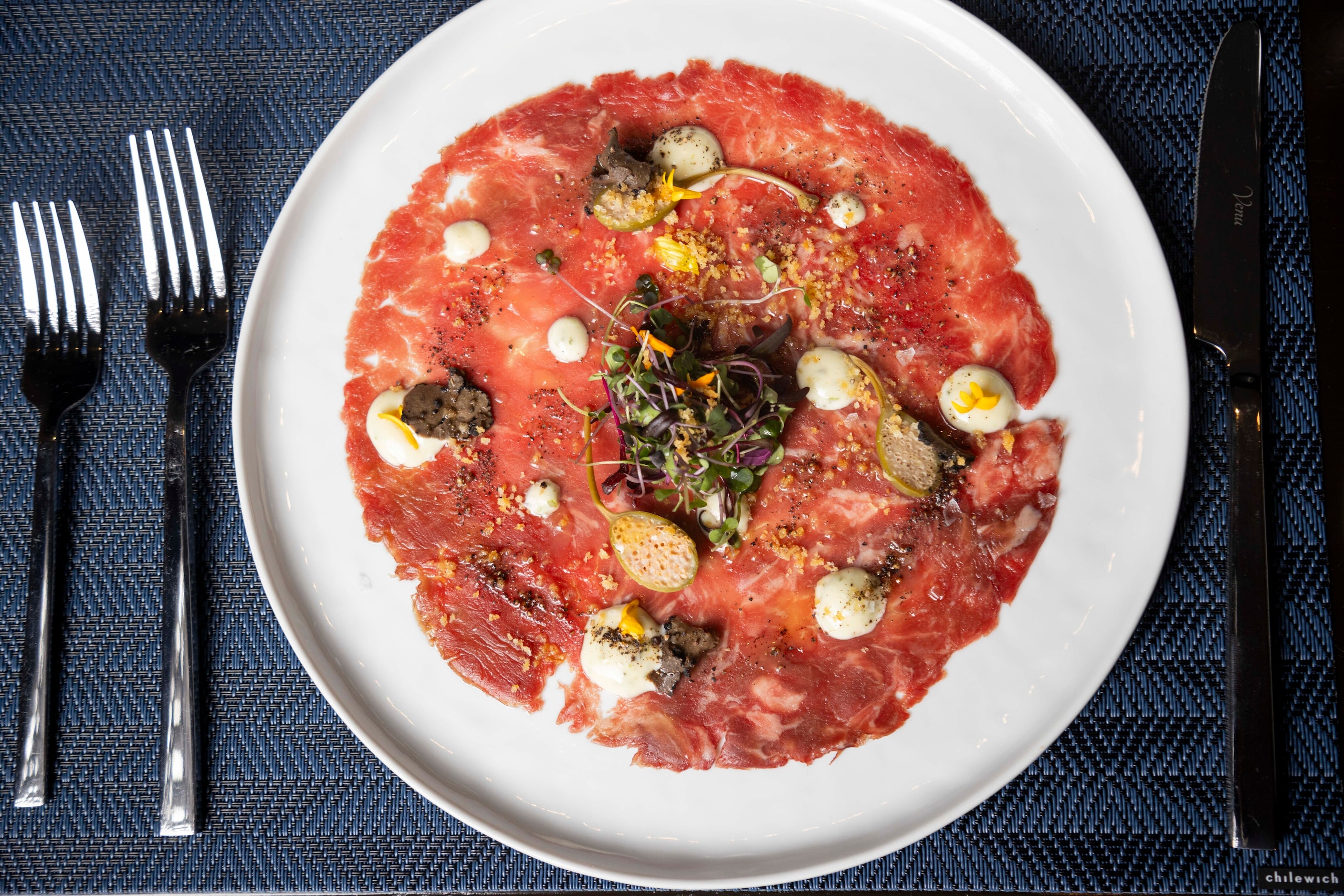 Beef Carpaccio is an appetizer at Wicked Butcher, located in the Comerica Bank Tower in...