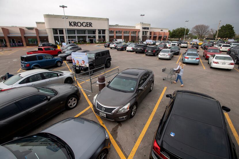 A patron pushed a shopping cart through the parking lot of Kroger at Mockingbird and...