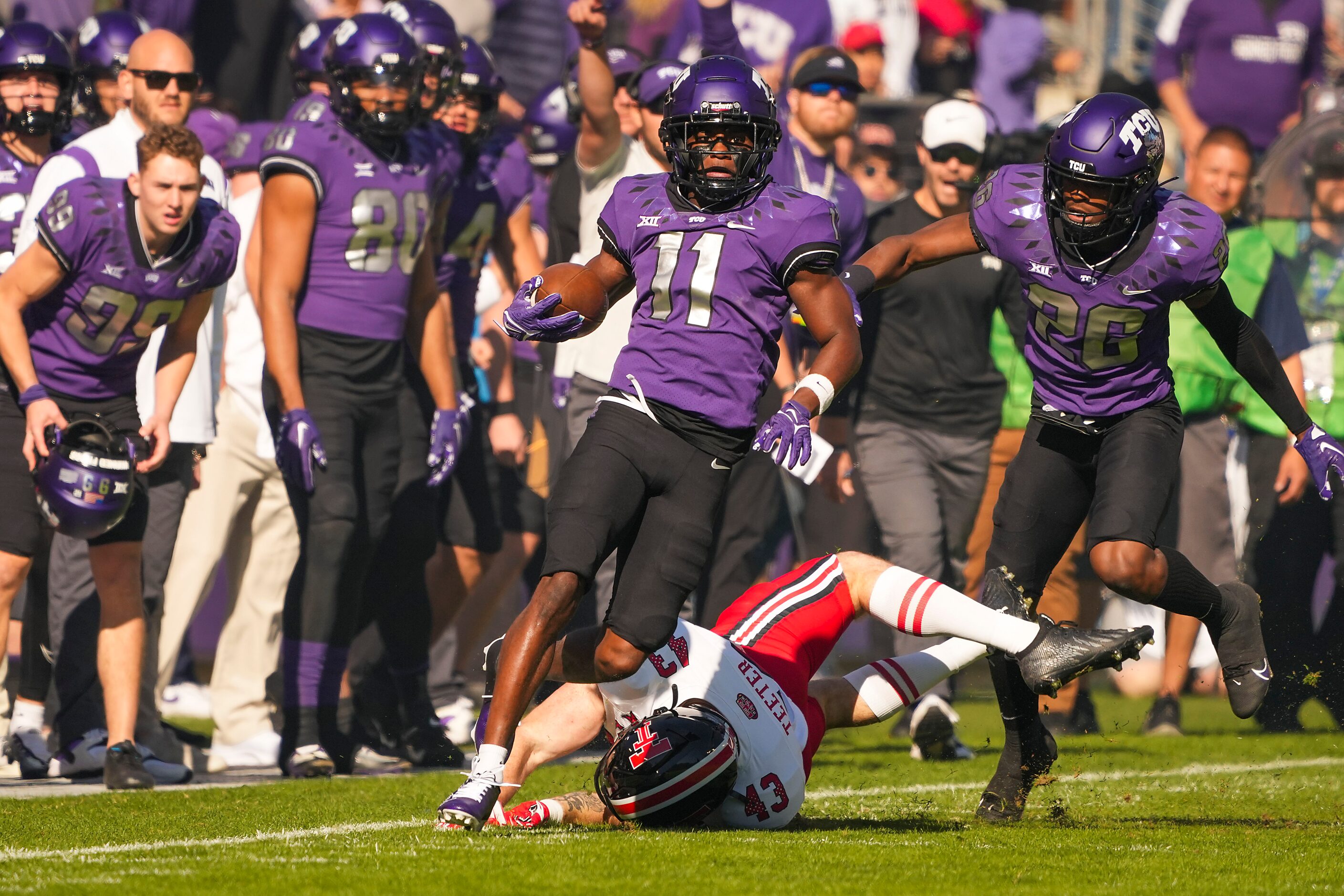 TCU wide receiver Derius Davis (11) gets past Texas Tech’s Henry Teeter (43) on an 82-yard...