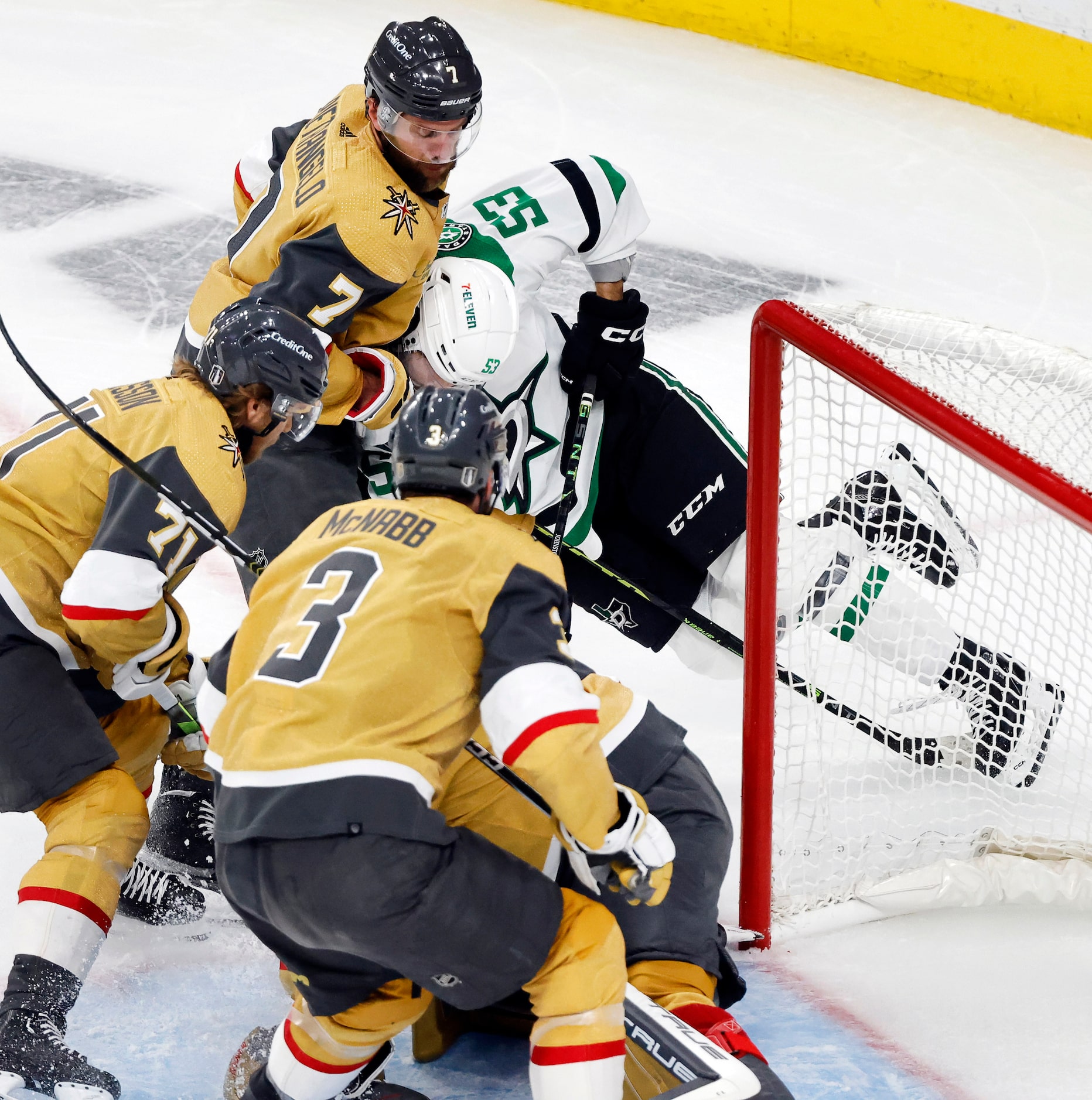 Dallas Stars center Wyatt Johnston (53) is crushed by a Vegas Golden Knights defenseman Alex...