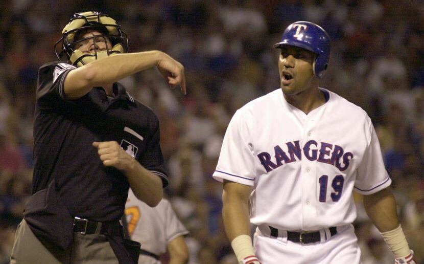 Texas Rangers' Juan Gonzalez (19) is tossed from the game by home plate umpire Jeff Nelson,...