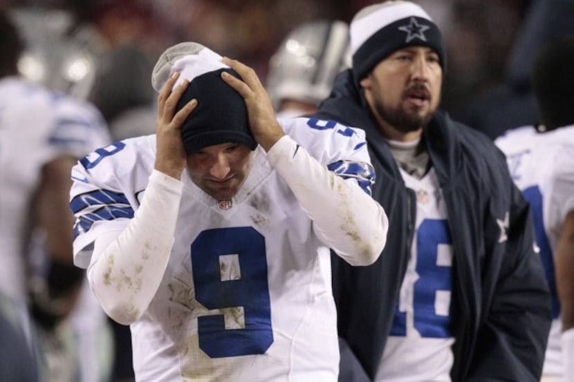 Dallas Cowboys quarterback Tony Romo (9) reacts an the bench after he threw an interception...