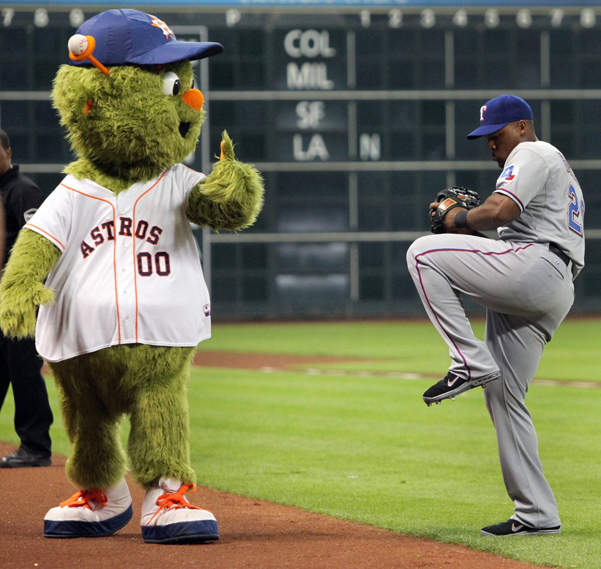 Texas third baseman Adrian Beltre gets some advice from Astros mascot "Orbit" before the...