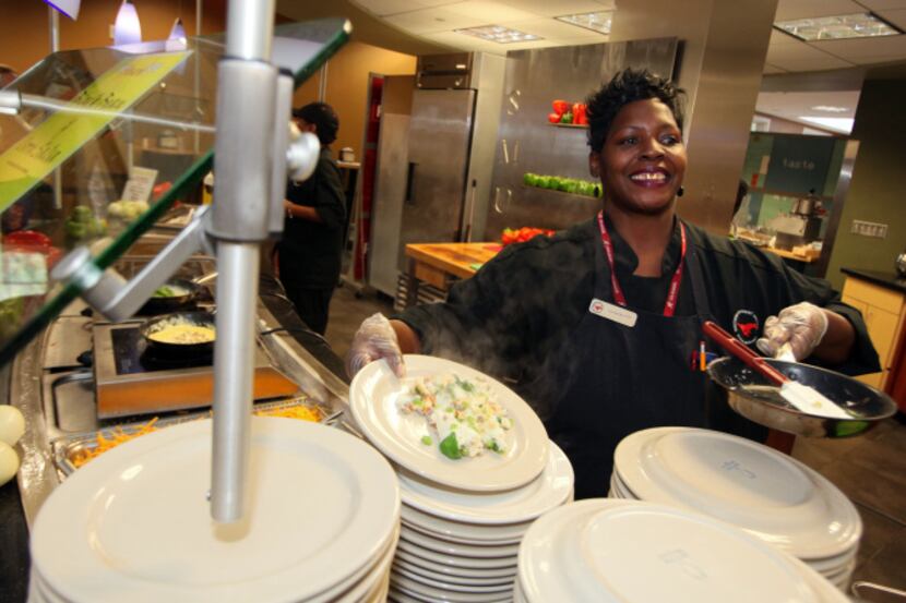 Tamerlyn Holmes, right, also known as Momma T, finishes a freshly made omelette, on Sept....