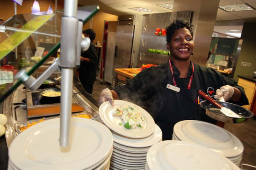 Tamerlyn Holmes, right, also known as Momma T, finishes a freshly made omelette, on Sept....