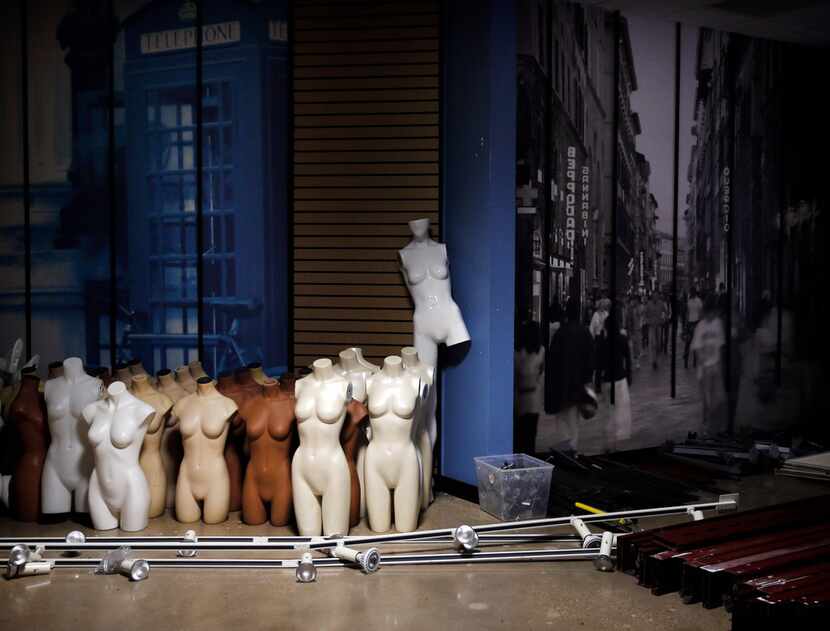 Mannequins and track lighting are stacked in the corner of the Rue 21 store inside the empty...