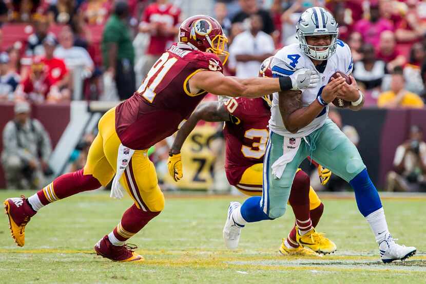 Dallas Cowboys quarterback Dak Prescott (4) gets past Washington Redskins outside linebacker...