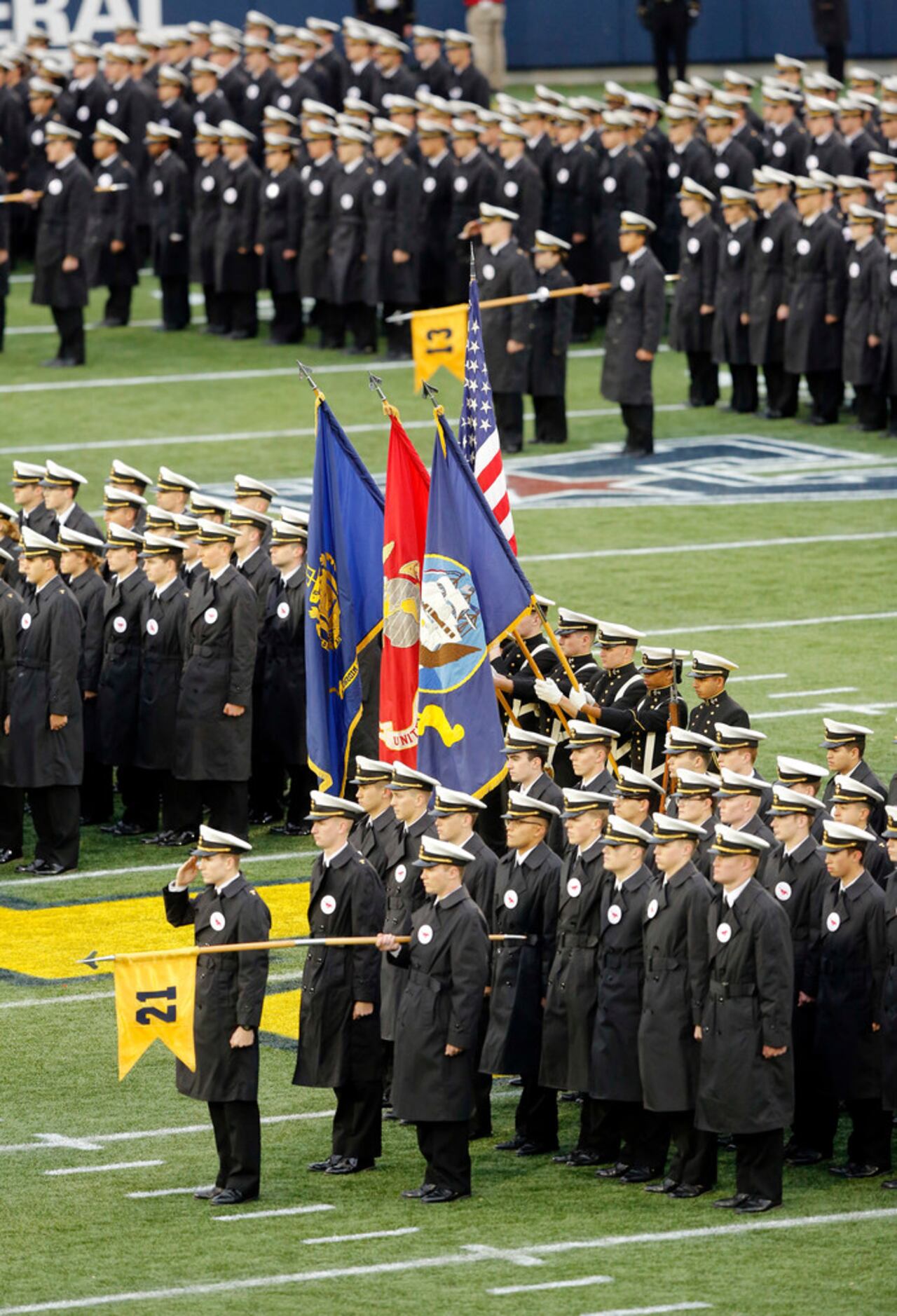 Navy Midshipmen line the field during pregame ceremonies and the national anthem before...
