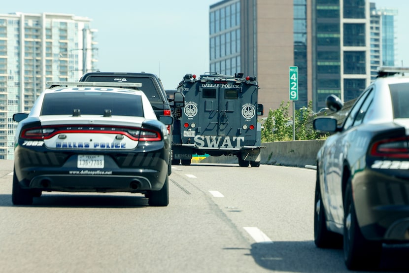 Dallas police and SWAT travel along Interstate 35E as they head to execute a search warrant...