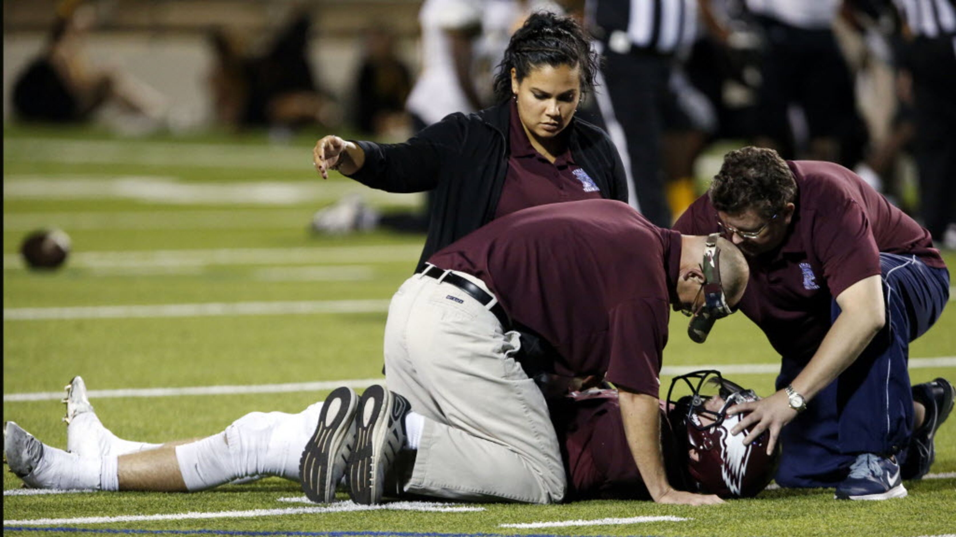 (TXHSFB) Trainers attend to injured Rowlett QB Logan Bonner (12), after he was injured late...