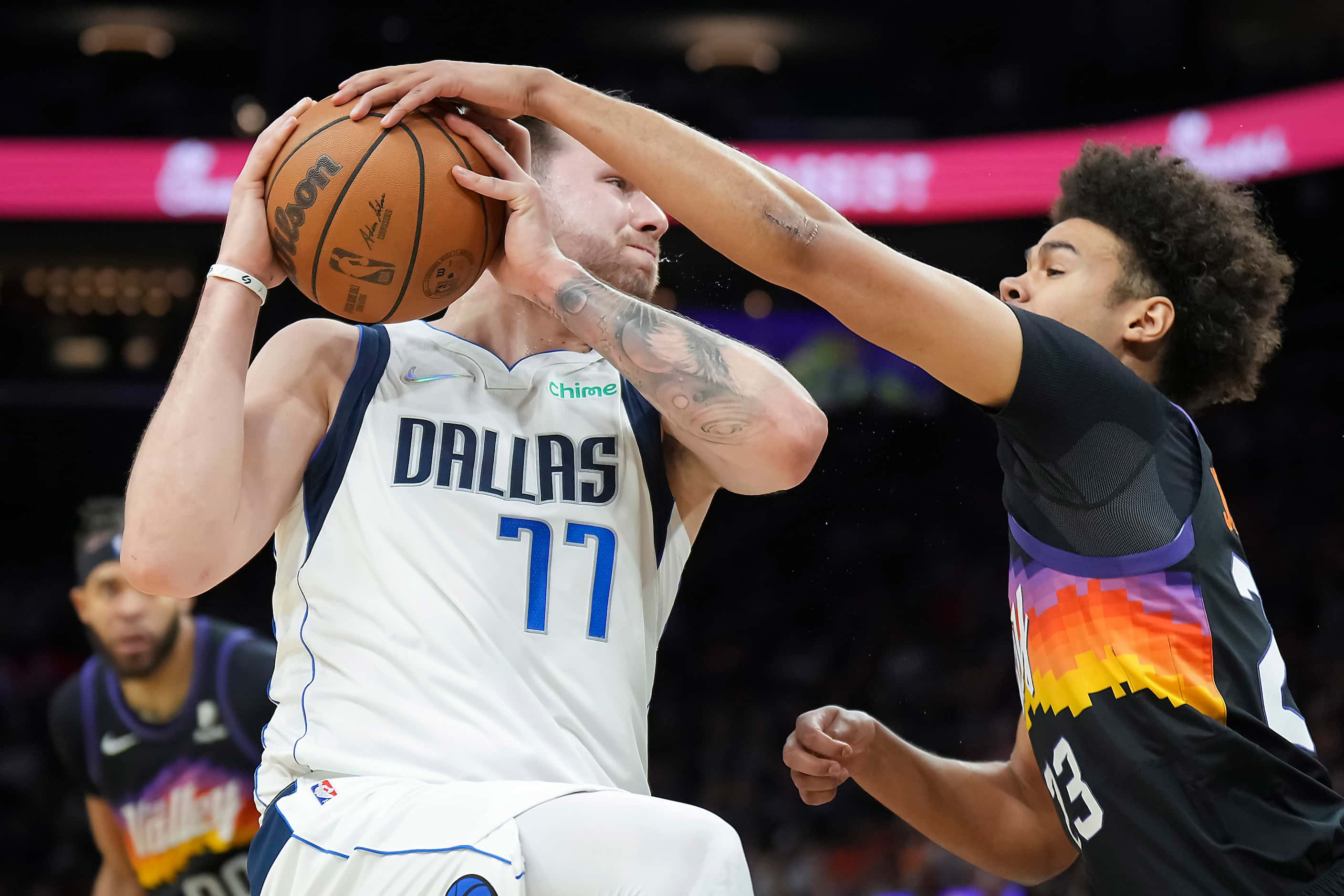 Dallas Mavericks guard Luka Doncic (77) is defended by Phoenix Suns forward Cameron Johnson...