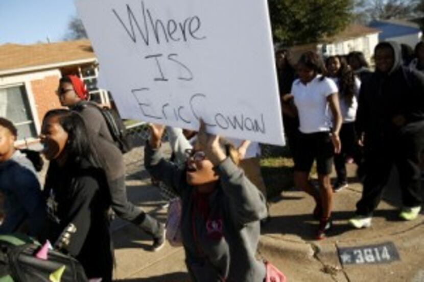  Eleventh-grader Caprisha Taylor holds up a sign during a walk-out protest against the...
