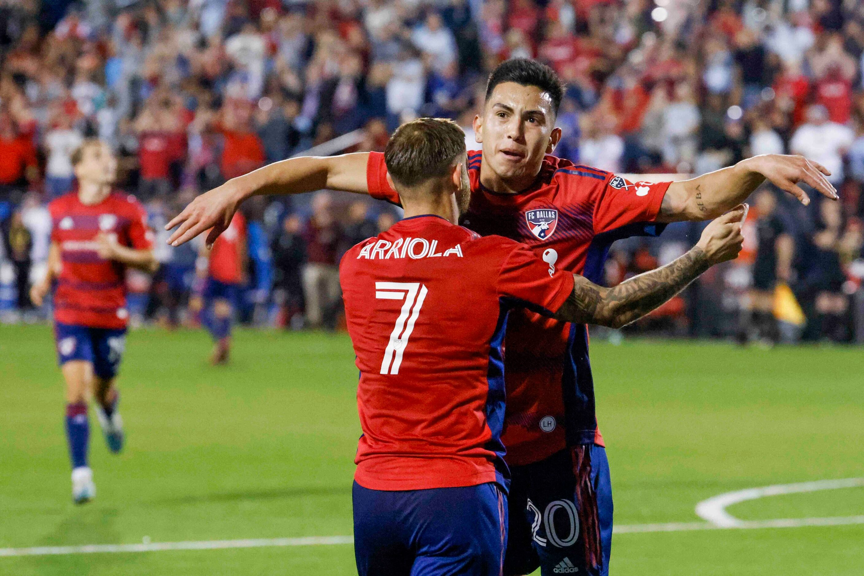 FC Dallas forward Alan Velasco (back) and forward Paul Arriola celebrates a goal during the...