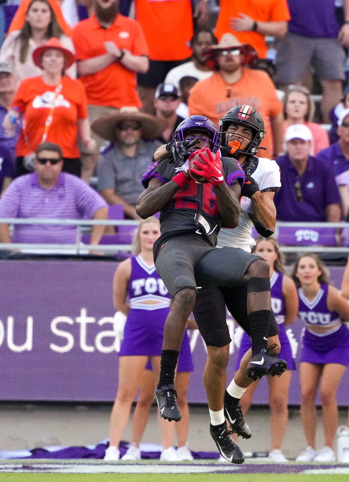 TCU safety Bud Clark (26) intercepts a pass intended for Oklahoma State wide receiver...