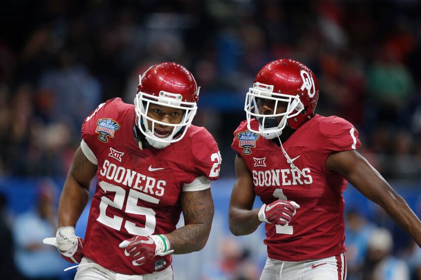 Oklahoma running back Joe Mixon (25) celebrates his touchdown with wide receiver Jarvis...