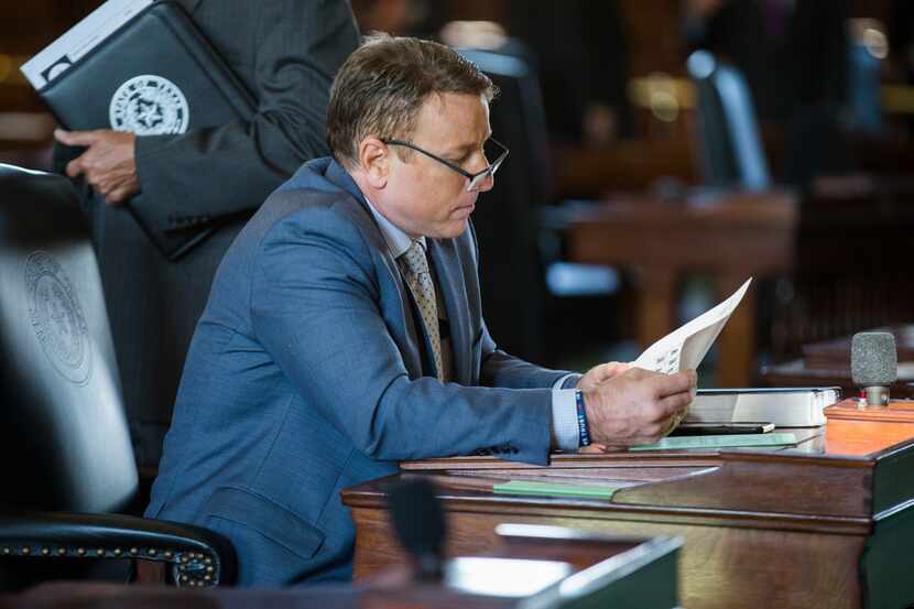 Sen. Pat Fallon looked over documents on the second day of the 86th Texas Legislature at the...