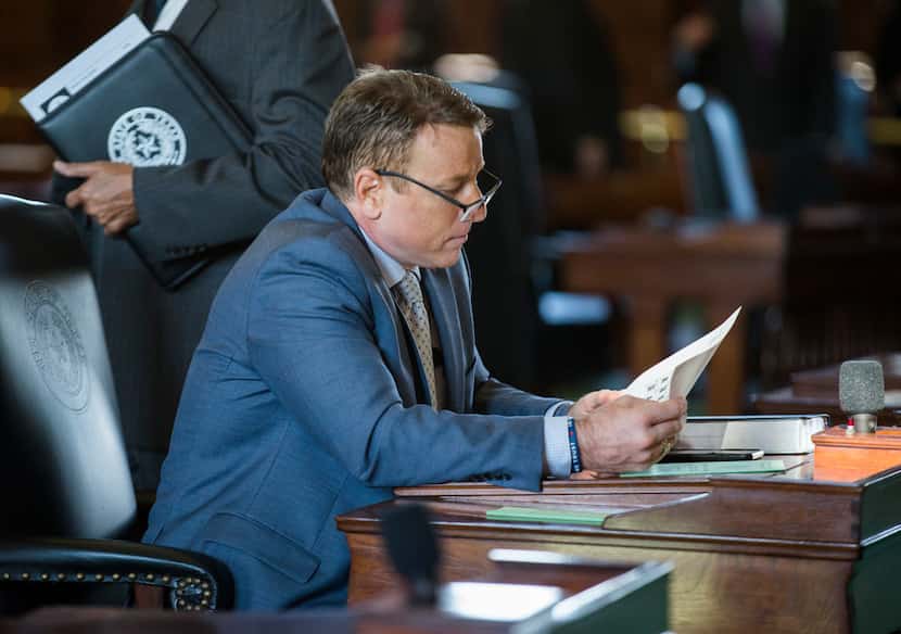 Sen. Pat Fallon looks over documents on the second day of the 86th Texas Legislature on Jan....