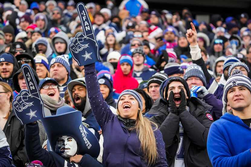 Dallas Cowboys fans celebrate after a New York Giants turnover on downs during the second...