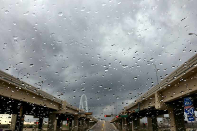 Light rain falls downtown as storms roll through the area Saturday, March 11, 2017, seen...