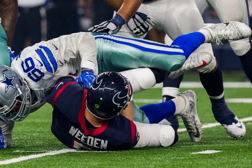 Dallas Cowboys defensive end Mike McAdoo (66) sacks Houston Texans quarterback Brandon...