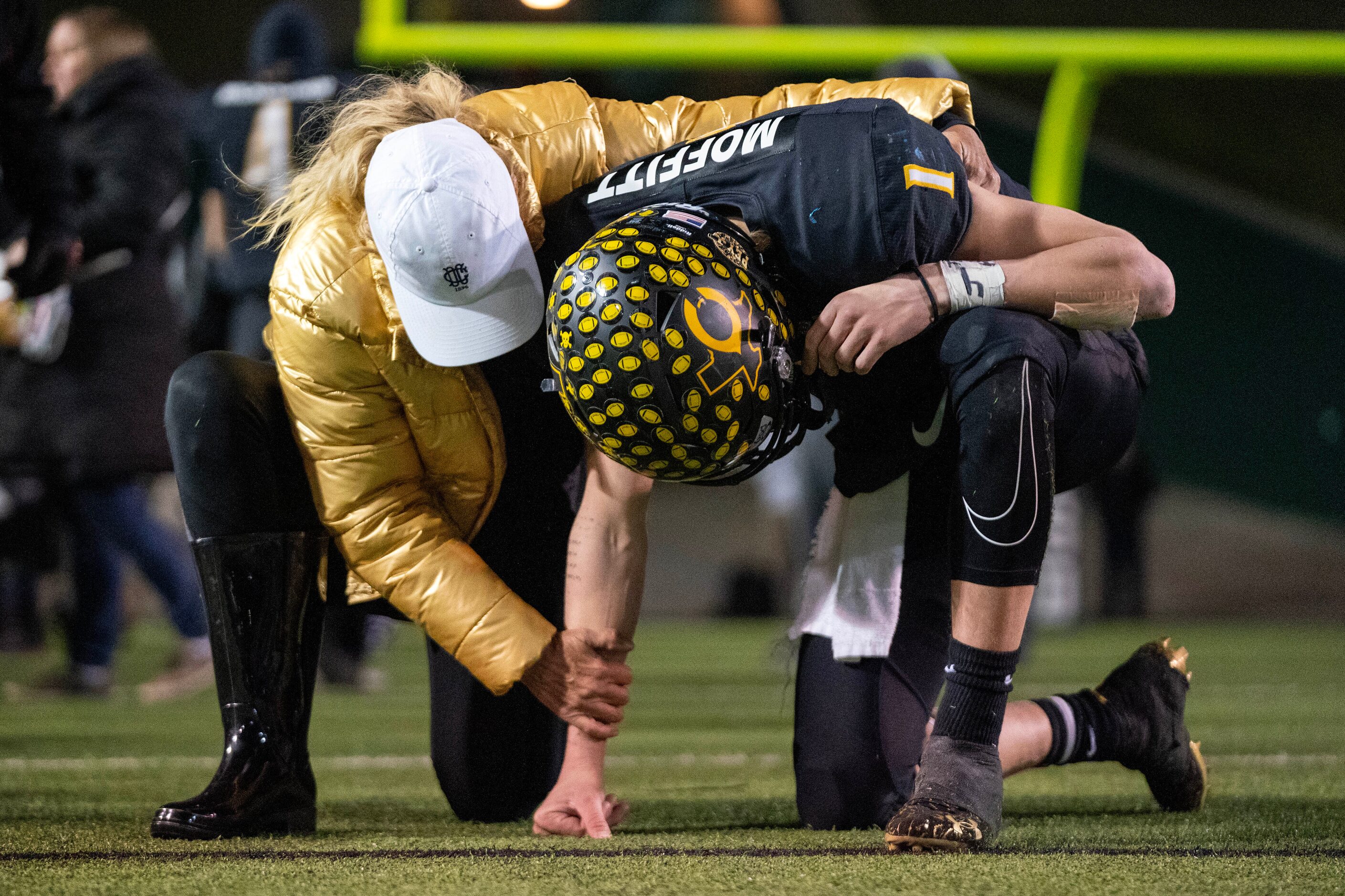 Crandall senior quarterback Luke Moffitt (1) is comforted by his mother Libbie Moffitt after...