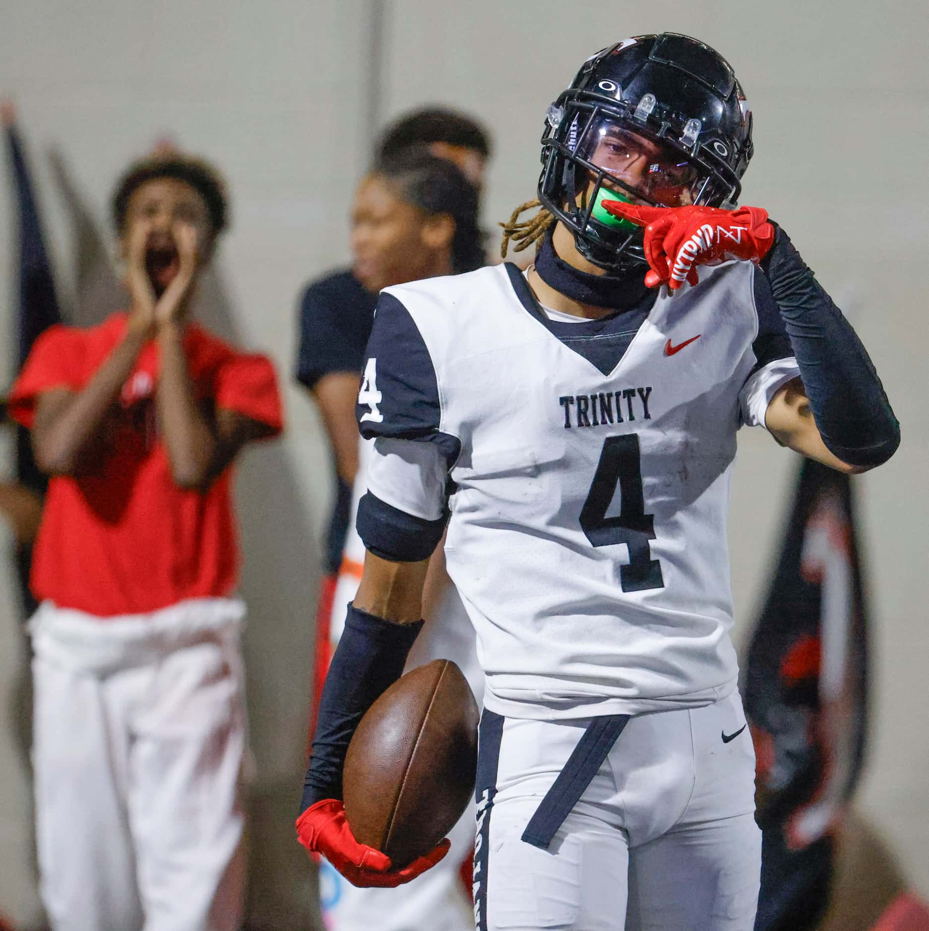 Trinity High’s Jarvis Heimuli celebrates after scoring a touchdown against Crowley High...
