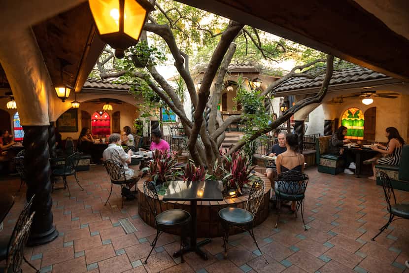 Diners outside in the patio area at Kalachandji's vegetarian restaurant on Gurley Avenue in...
