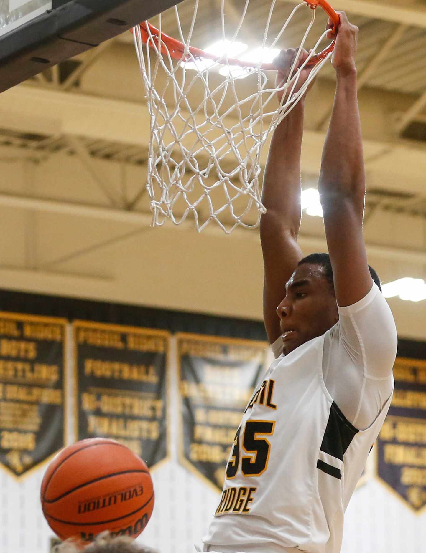 Fossil Ridge High School Donovan Goff (35) dunks the ball into the net during the second...