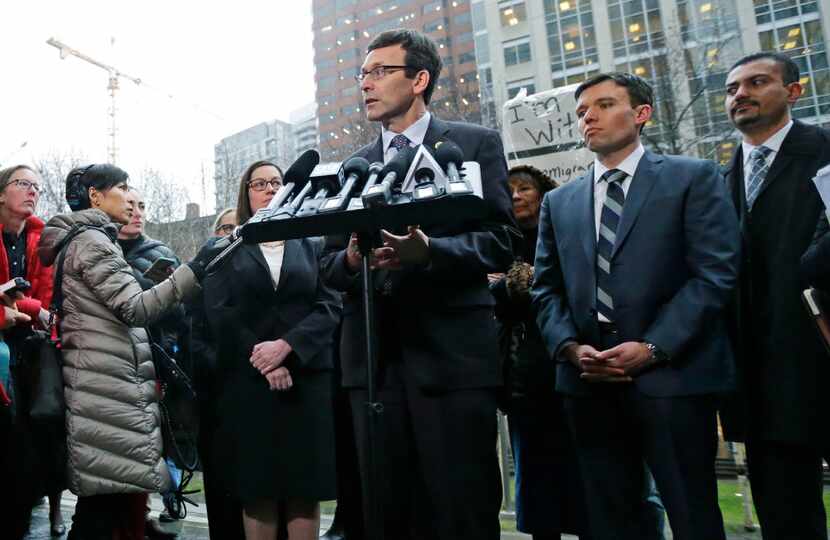 Washington Attorney General Bob Ferguson talks to reporters as Solicitor General Noah...