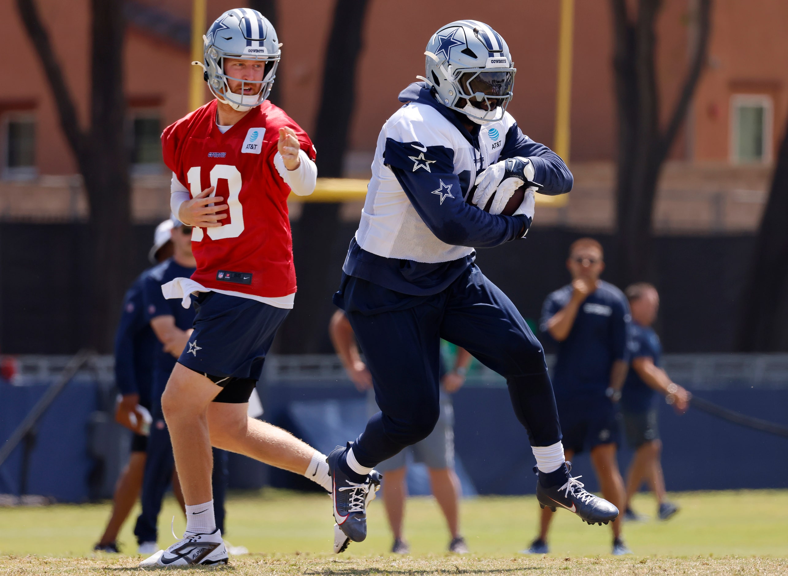 Dallas Cowboys running back Ezekiel Elliott (15) takes a hand off from quarterback Cooper...