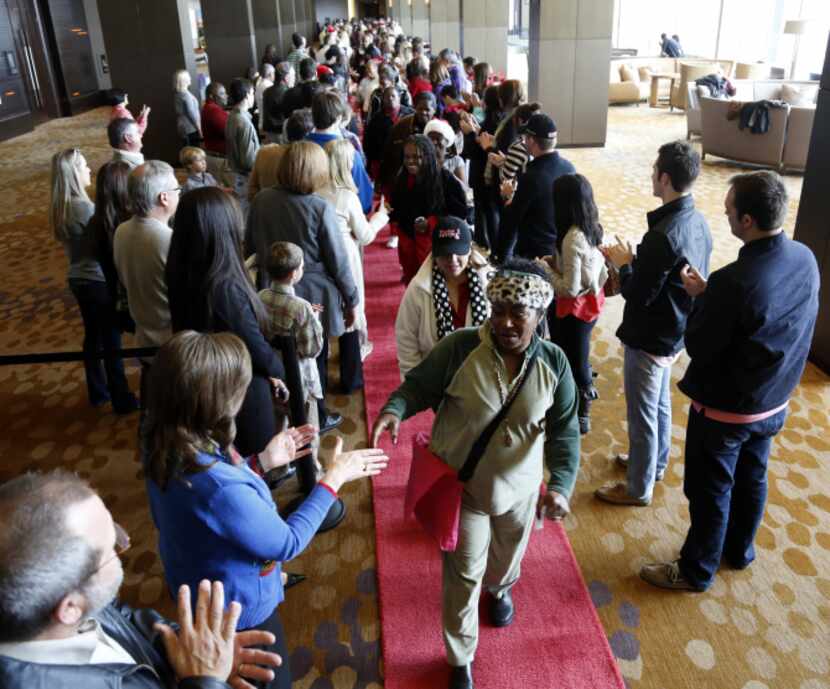 Hundreds of volunteers greet 500 homeless people at the Omni Dallas Hotel on Monday