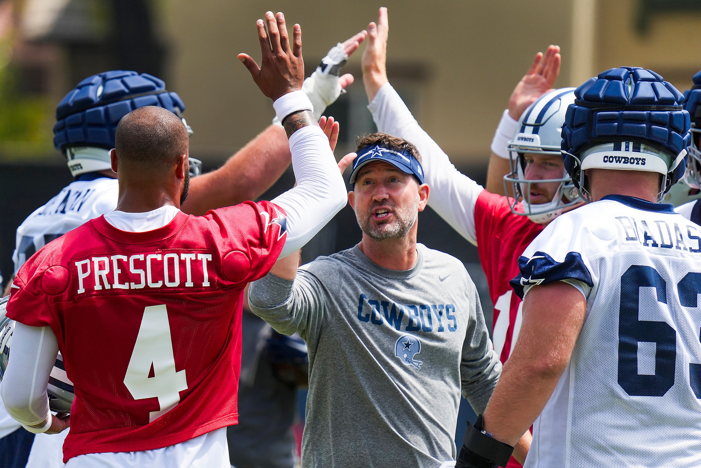 Dallas Cowboys offensive coordinator Brian Shottenheimer high fives quarterback Dak Prescott...