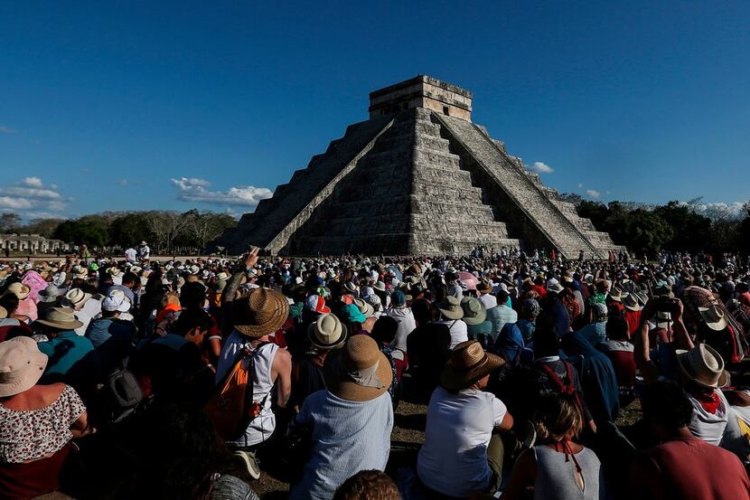 People surround the El Castillo pyramid at the Mayan archaeological site of Chichen Itza in...