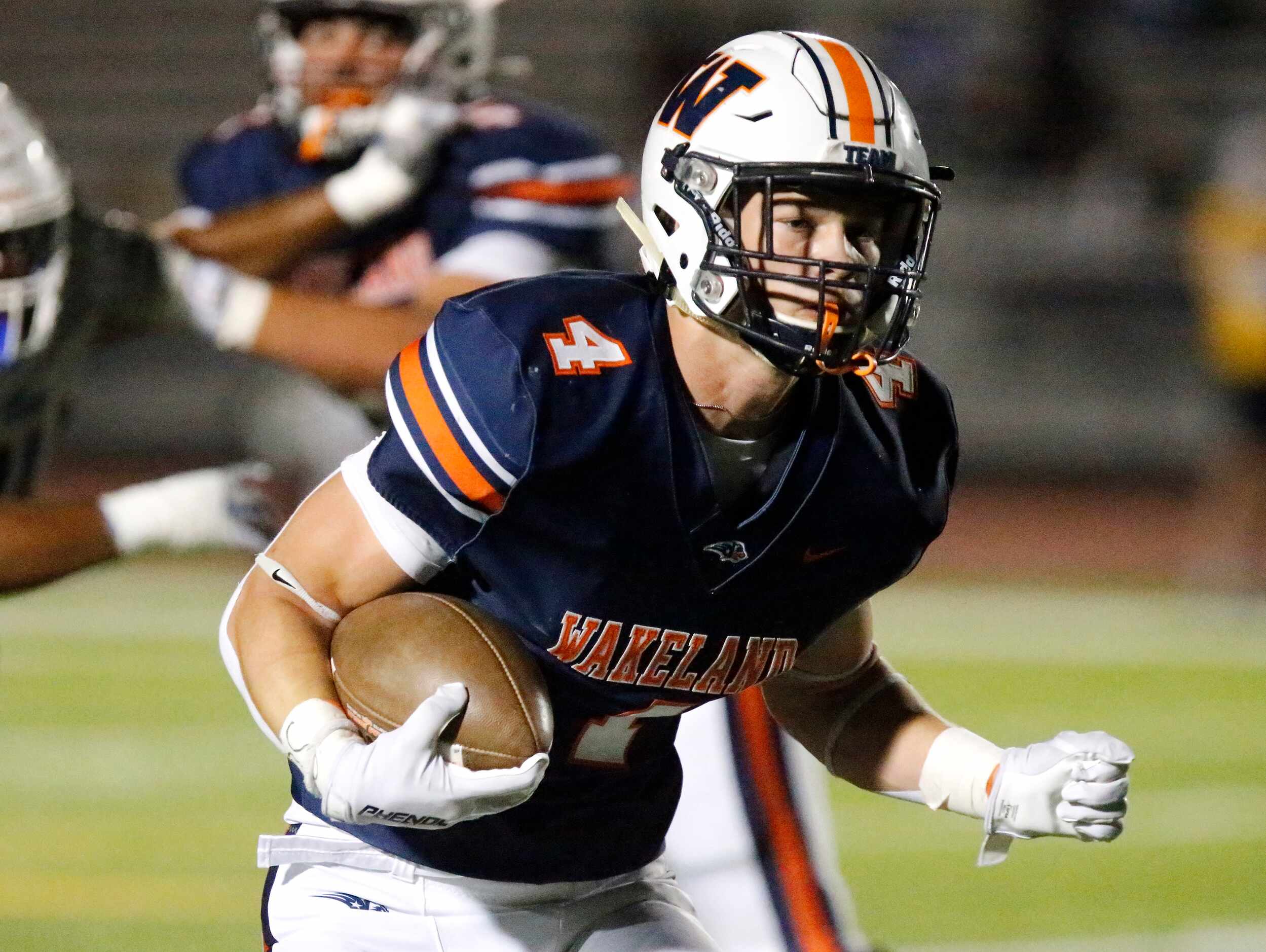 Wakeland High School running back Cooper Snyder (4) looks for running room during the first...