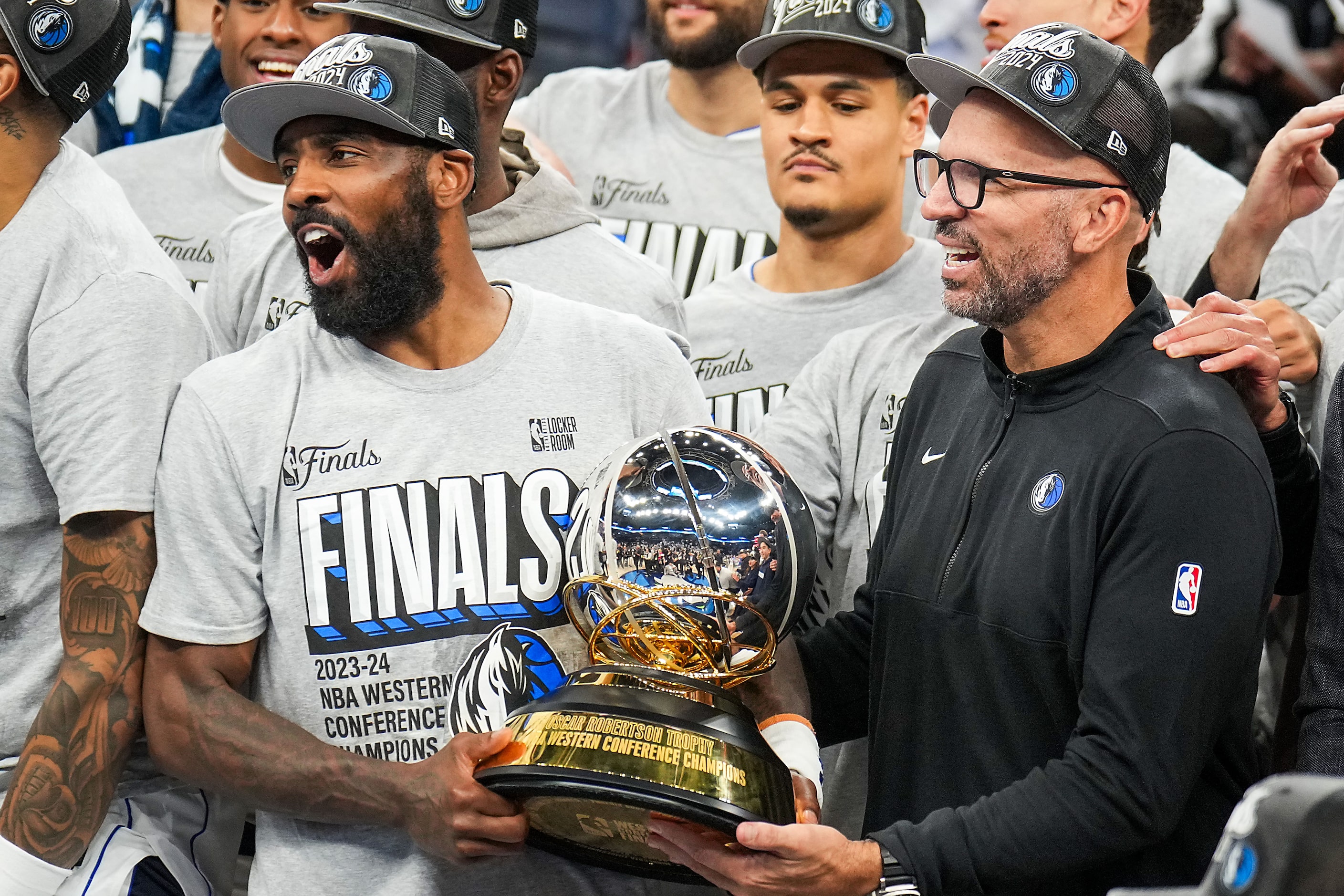 Dallas Mavericks guard Kyrie Irving (left) and head coach Jason Kidd celebrate with the...