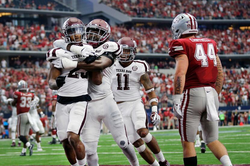 Texas A&M Aggies defensive back Armani Watts (23, right) is congratulated by linebacker...