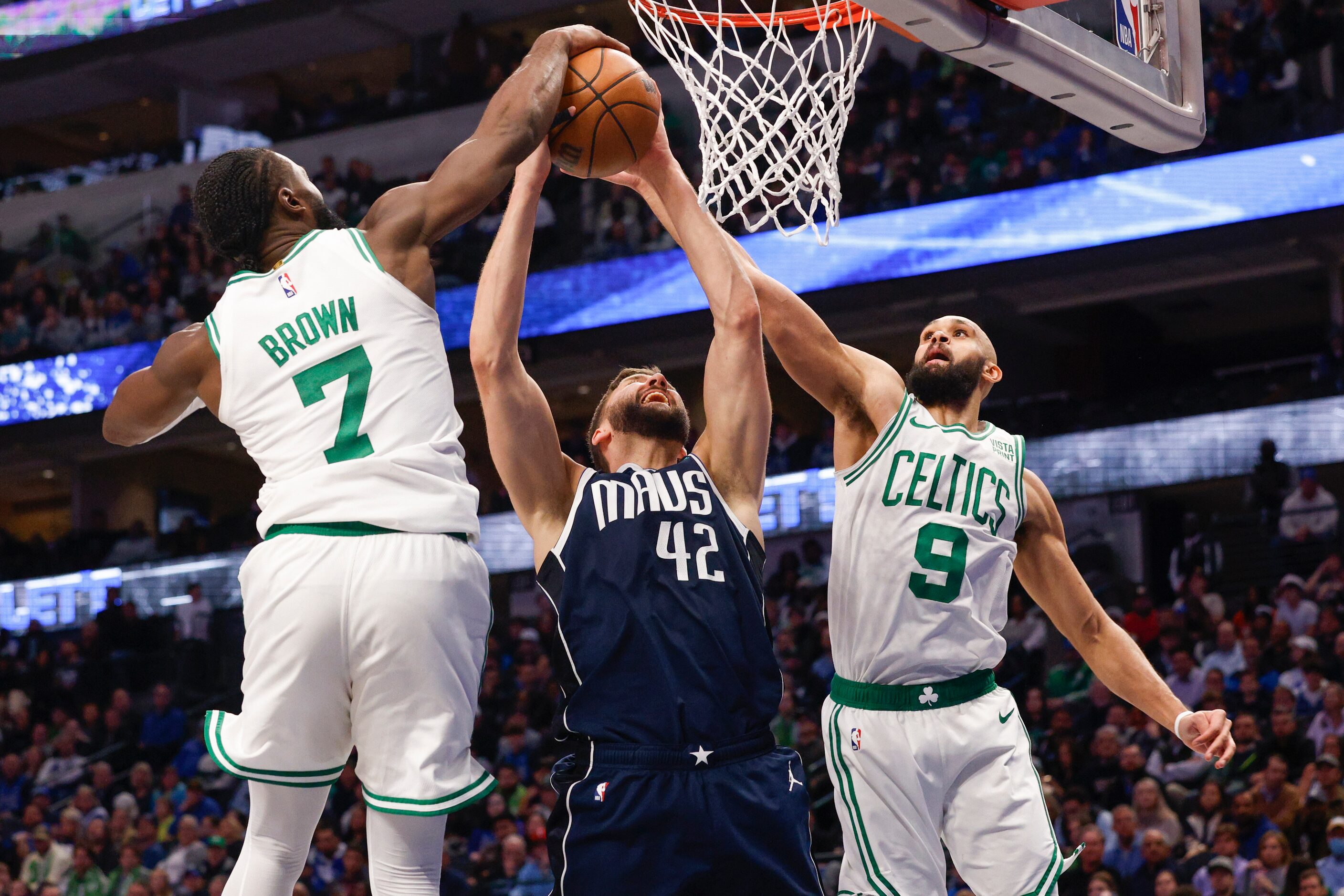 Boston Celtics guard Jaylen Brown (7) and guard Derrick White (9) block a shot from Dallas...