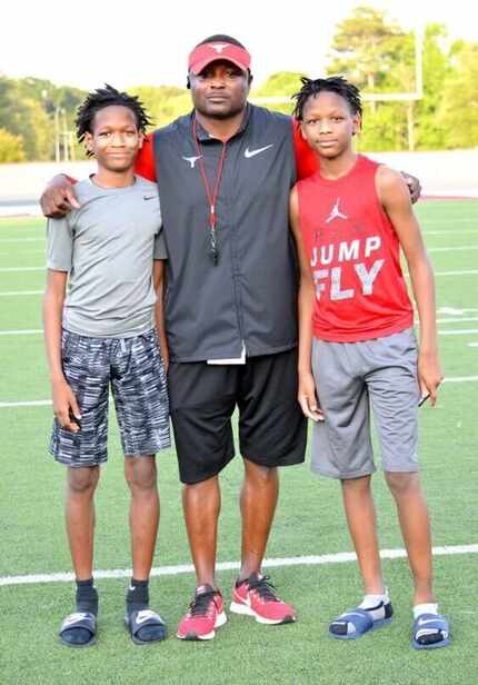 DeSoto football coach Claude Mathis with his sons, Crimson (left) and Caimon (right).