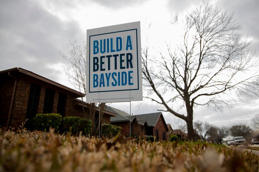 A "Build a Better Bayside" sign is planted in a homeowner's yard in a Rowlett neighborhood.
