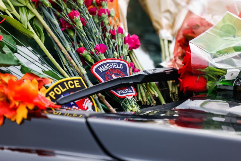 A memorial outside of the Grand Prairie Police Department for Officer Brandon Tsai.