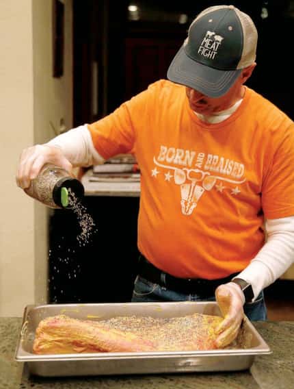 Here, Todd David of Cattleack Barbeque paints on a thin coating of mustard, which acts like...