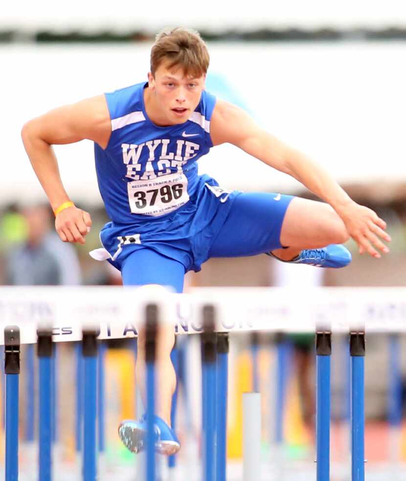 Justin Young, of Wylie East, clears  the final hurdle enroute to his first place finish in...