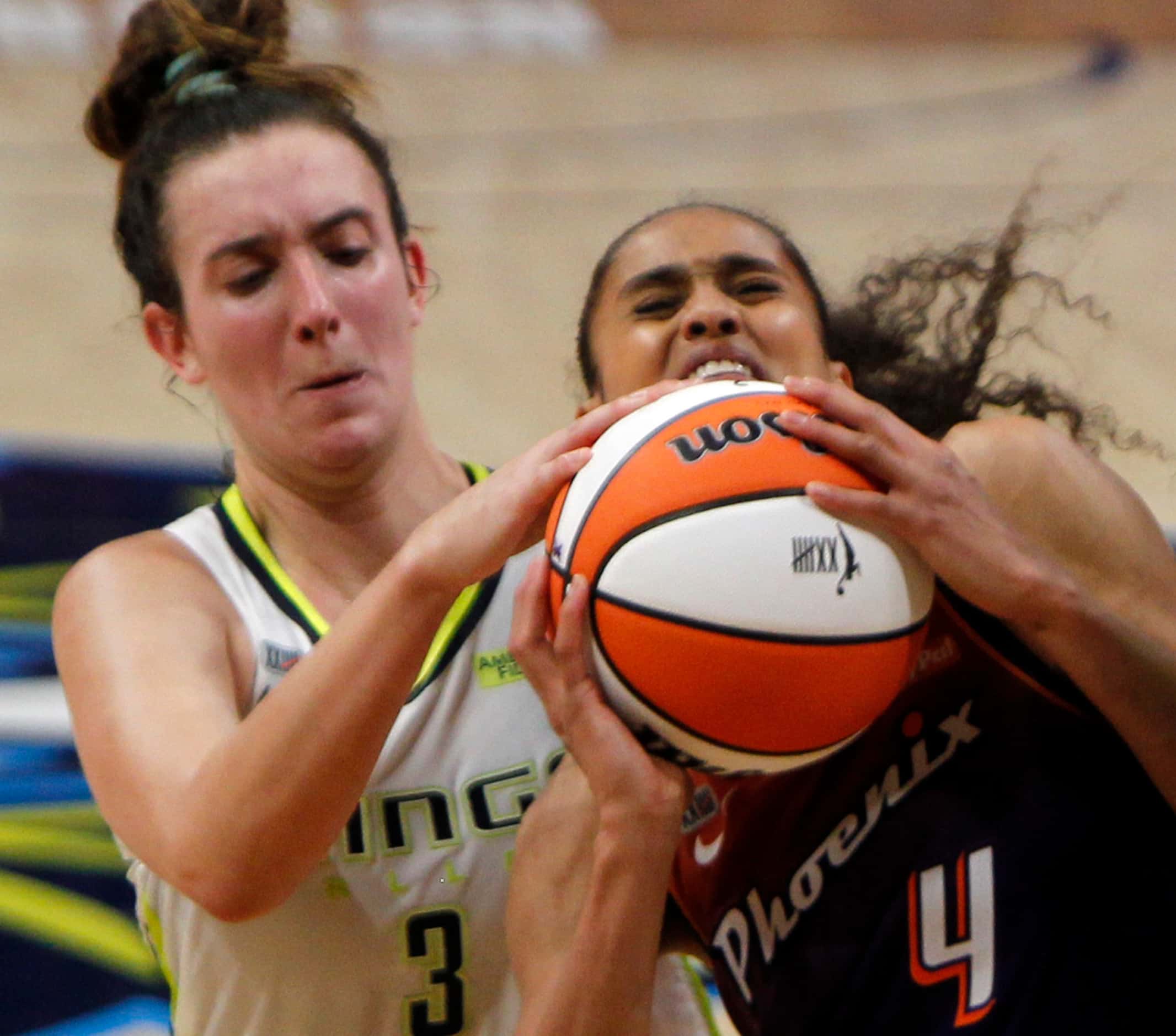 Dallas Wings guard Marina Mabrey (3), left, gets a hand on the ball before Phoenix guard...