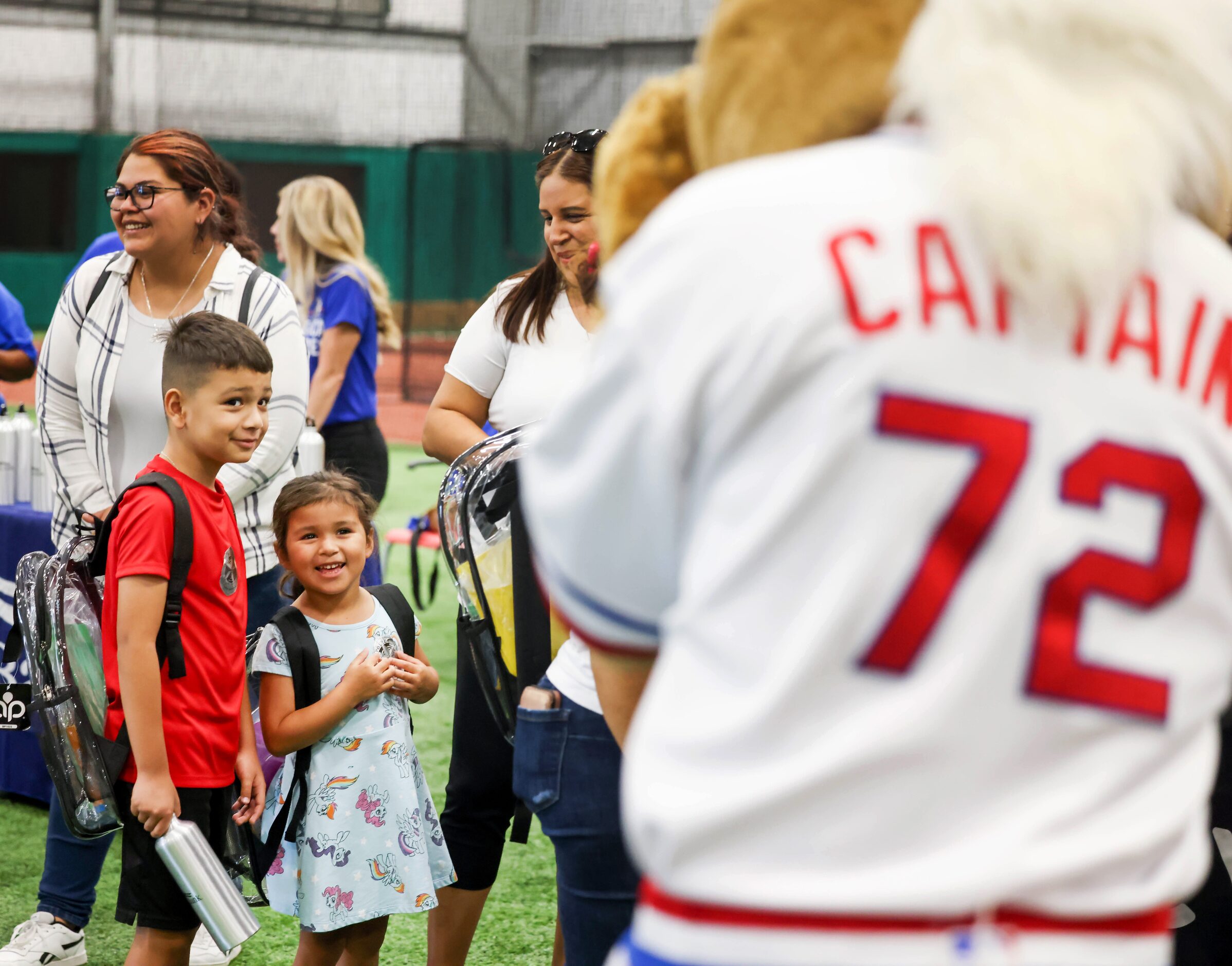 Josue Flores (left), 8, and Juliana Flores, 4, react to Texas Rangers mascot Captain...