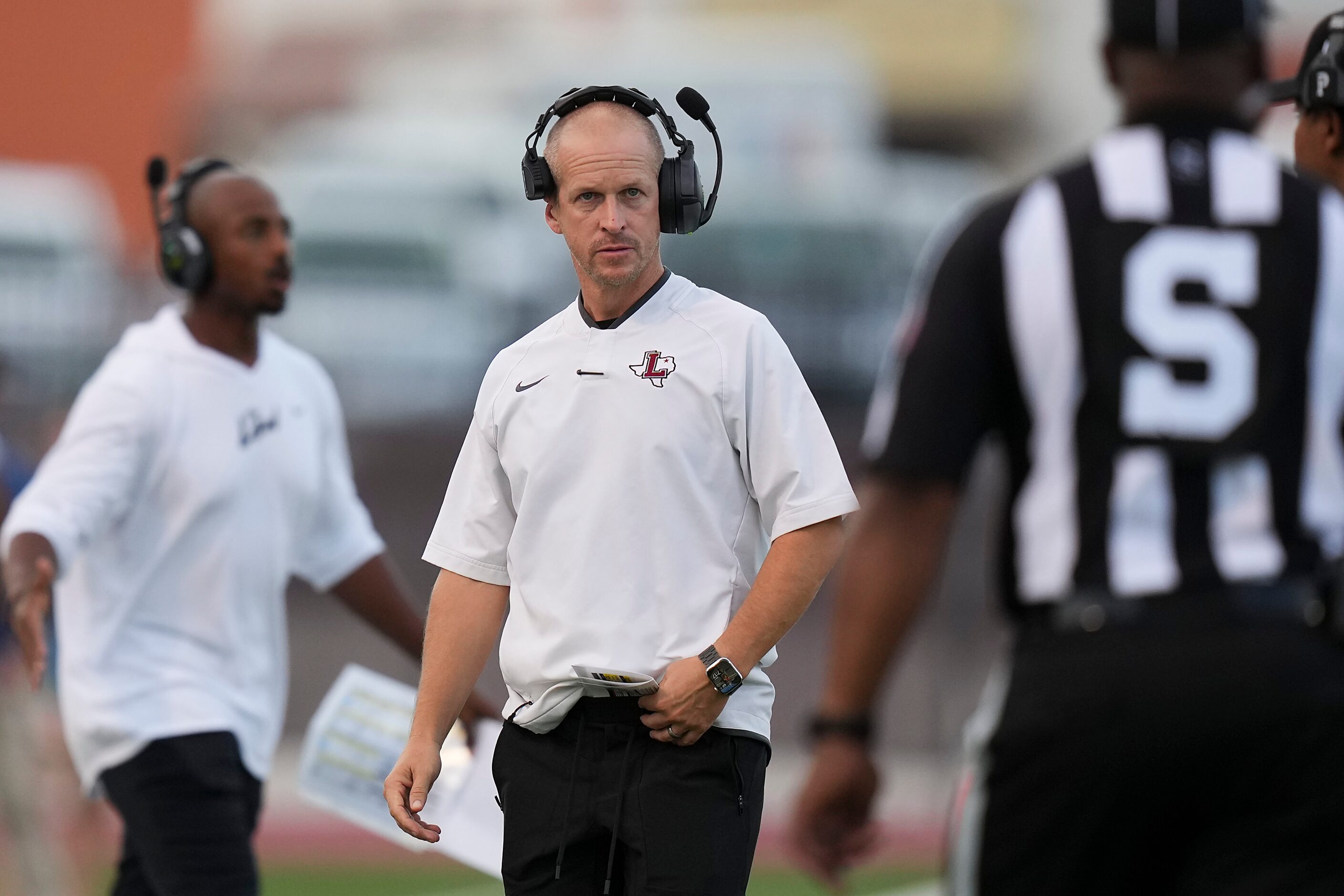 Lewisville head coach Michael Odle works the sidelines during the first half of a high...