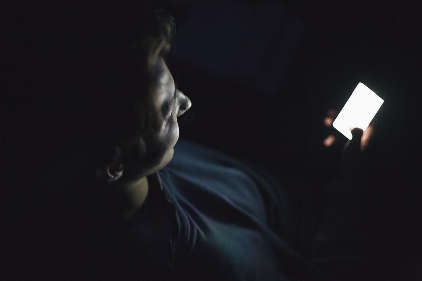 Teenage boy using smart phone.