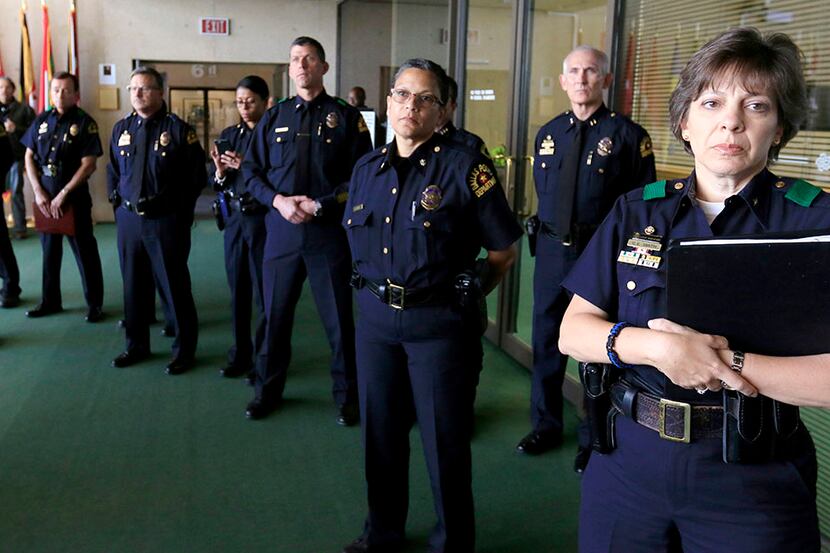  Members of the Dallas Police Department listen to Mayor Mike Rawlings and Dallas Police...