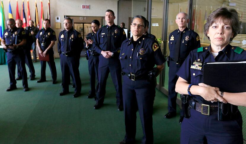  Members of the Dallas Police Department listen to Mayor Mike Rawlings and Dallas Police...