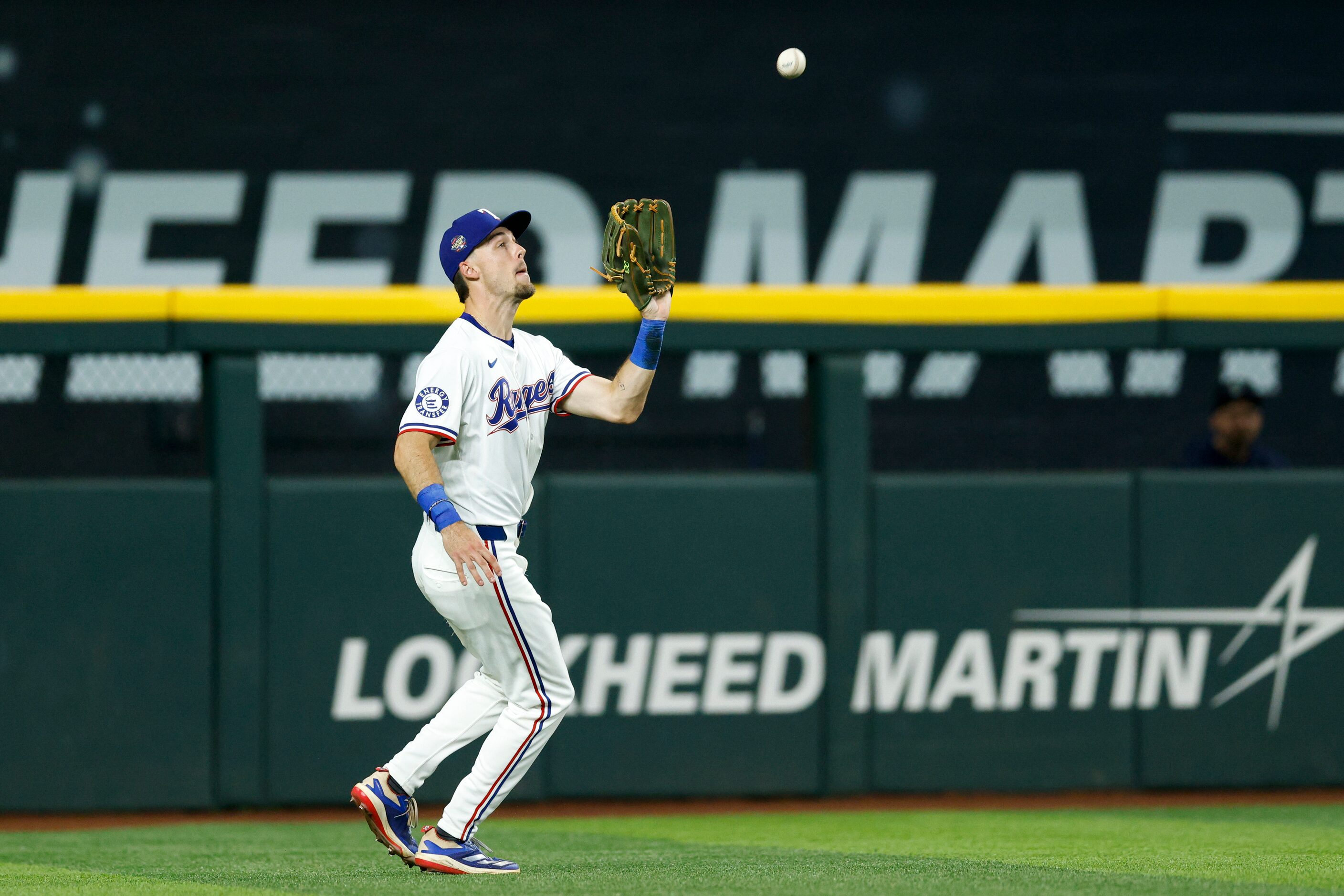 Texas Rangers left fielder Evan Carter (32) catches a ball off the bat of Seattle Mariners...